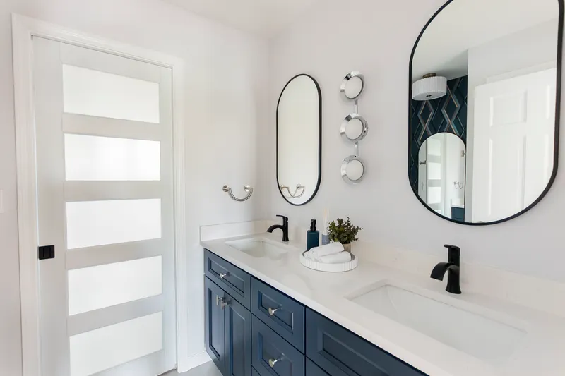 Bathroom renovation - wide angle of navy vanity